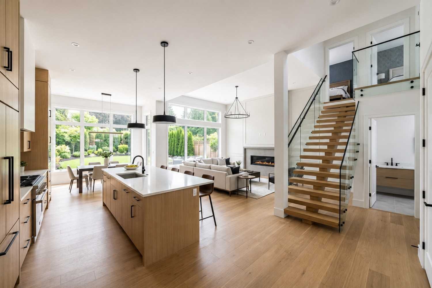 Modern open-concept home with kitchen, staircase, and living area.