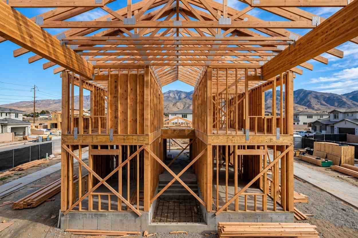Two-story wood frame house under construction.