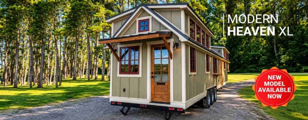 Modern luxury tiny home with a gabled roof, wood-framed windows, and a covered entryway surrounded by trees.